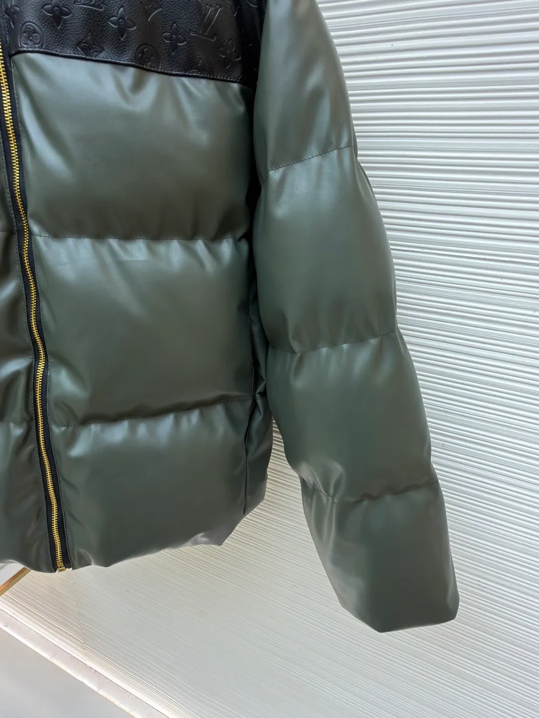 LOUIS VUITTON embossed splicing down jacket ●Original version: purchased and developed at 39599 ●Item number: 1682246-D35 ●Fabric: cotton fabric ●Technology: embossed production ●Version: fitted version ●Weight: about 1455 grams ●Size: 46-48-50-52 ●Description: This Louis Vuitton color-blocked down jacket is made with high-end craftsmanship. The main body of the jacket is made of high-grade artificial leather with a matte texture. It has been treated with water-repellent treatment and softened and polished multiple times. It has a delicate touch and is wrinkle-resistant. The shoulders and collar are spliced with black leather embossed with the classic Monogram pattern. The embossing process is hot-pressed with a precise temperature-controlled mold. The pattern has a uniform depth and a three-dimensional outline, restoring the brand's iconic elements. The filling layer adopts the golden ratio of 90% white goose down and 10% feathers. It is manually filled through the divided down filling process. The amount of down in each grid is precisely controlled to ensure that the warmth and fluffiness are evenly distributed. The metal zipper is made of custom-made brass and has been treated with gold-plated anti-oxidation treatment. The zipper teeth have high tightness and smooth pulling. The neckline is cut with a stand-up collar, which is fixed with three-dimensional stitching technology. The overall stitching adopts double-needle overlocking technology. The stitching is fine and flat, taking into account durability and light luxury texture. The details show the brand's ingenious craftsmanship. The overall wiring is straight and delicate, the fabric is comfortable and soft, and the color is consistent without color difference. It can be matched with the same style to create a fashionable look and control various occasions. Customized accessories, complete with three standards, same style for men and women!